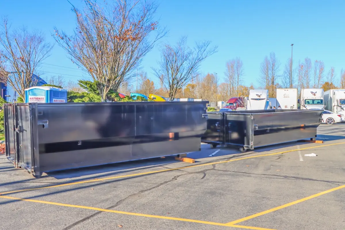 Professional dumpster rental service with roll-off container on residential driveway in Fredonia